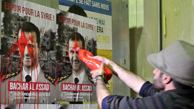 Syrian activists splash paint on President Assad&#039;s election posters