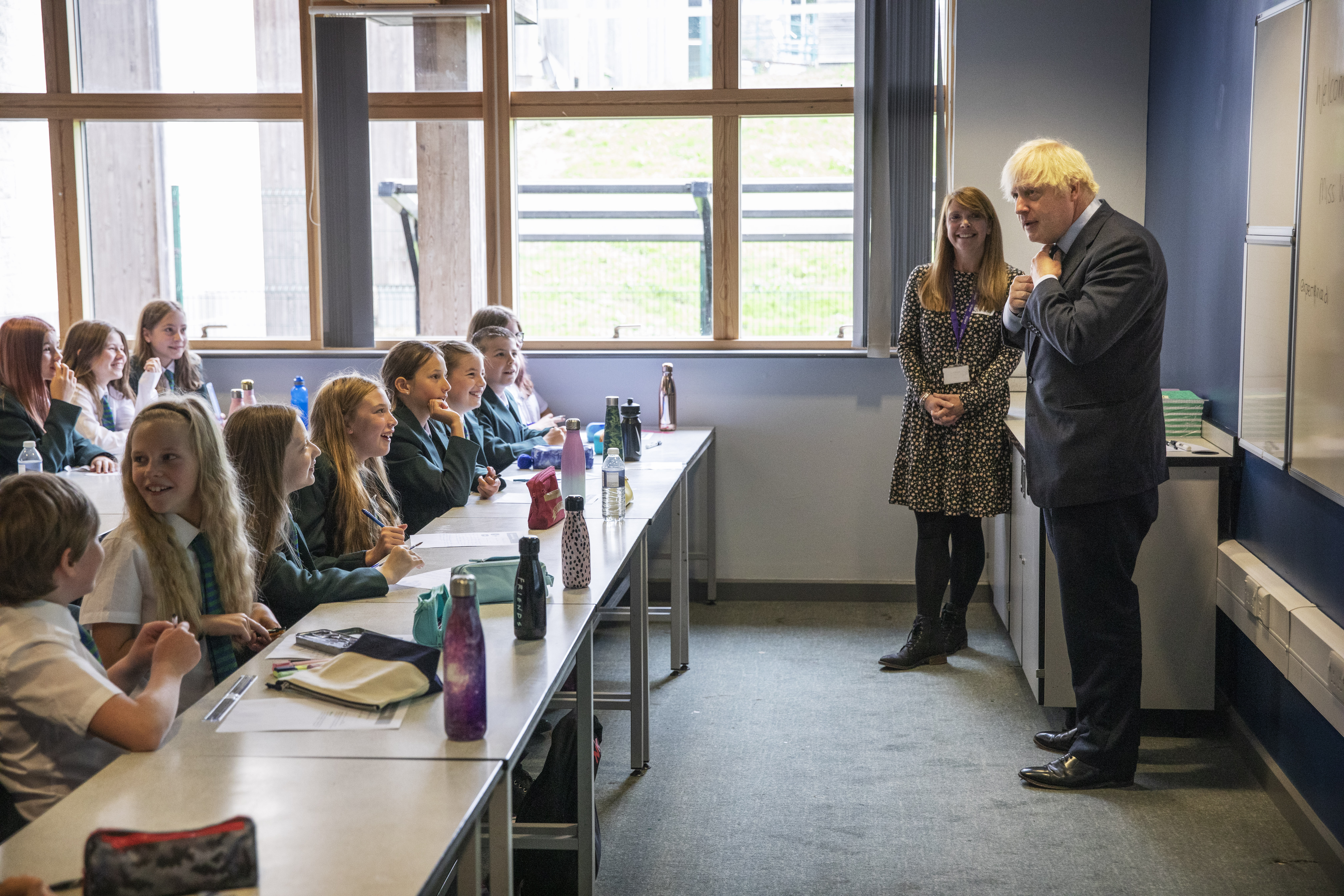 COALVILLE, ENGLAND- AUGUST 26: British Prime Minister Boris Johnson, wearing the school tie he was presented with on arrival, speaks to a class of year 7 pupils on their first day back at sch