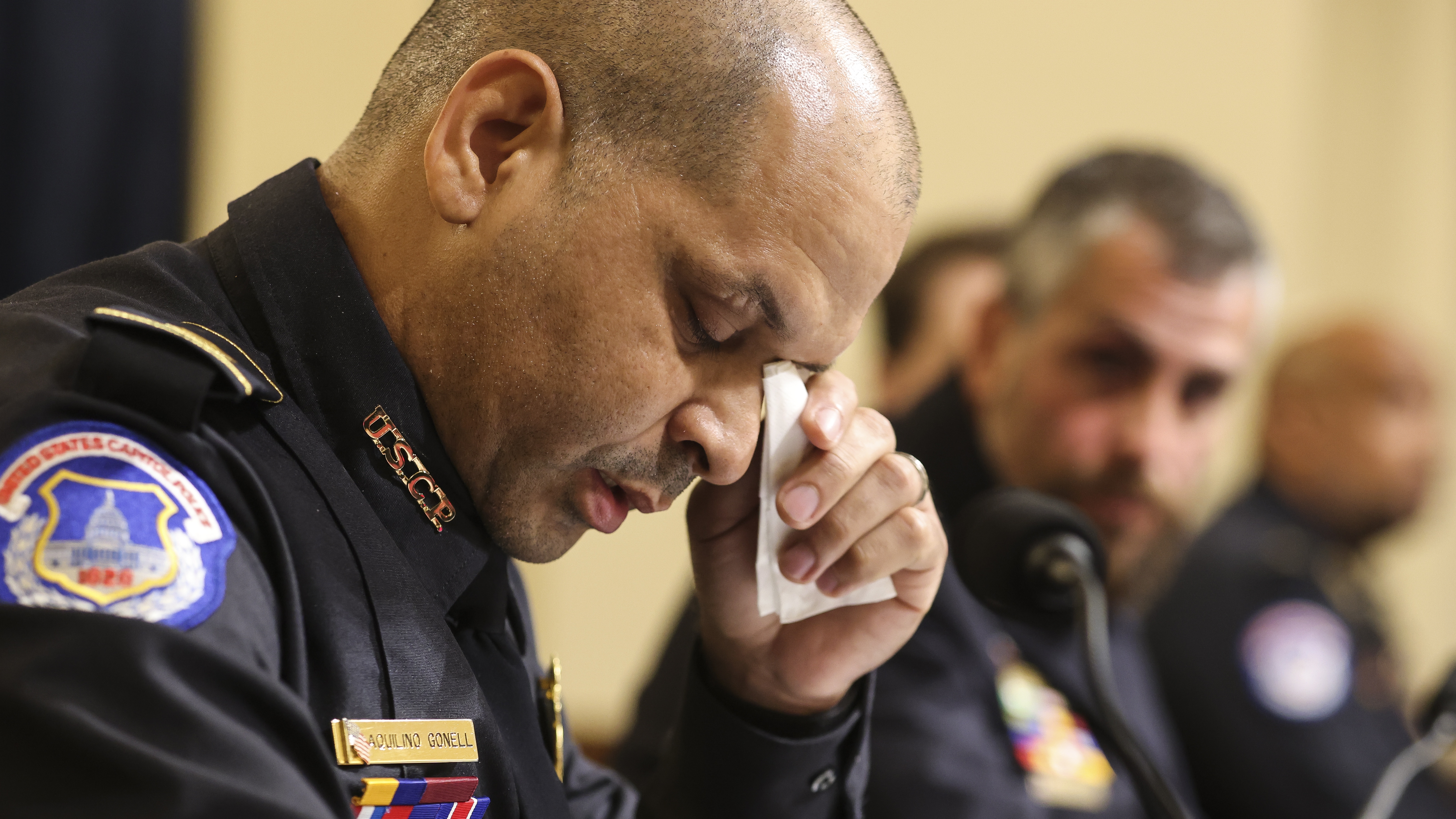 Capitol Police Sergeant Aquilino Gonell wipes away tear while giving evidence