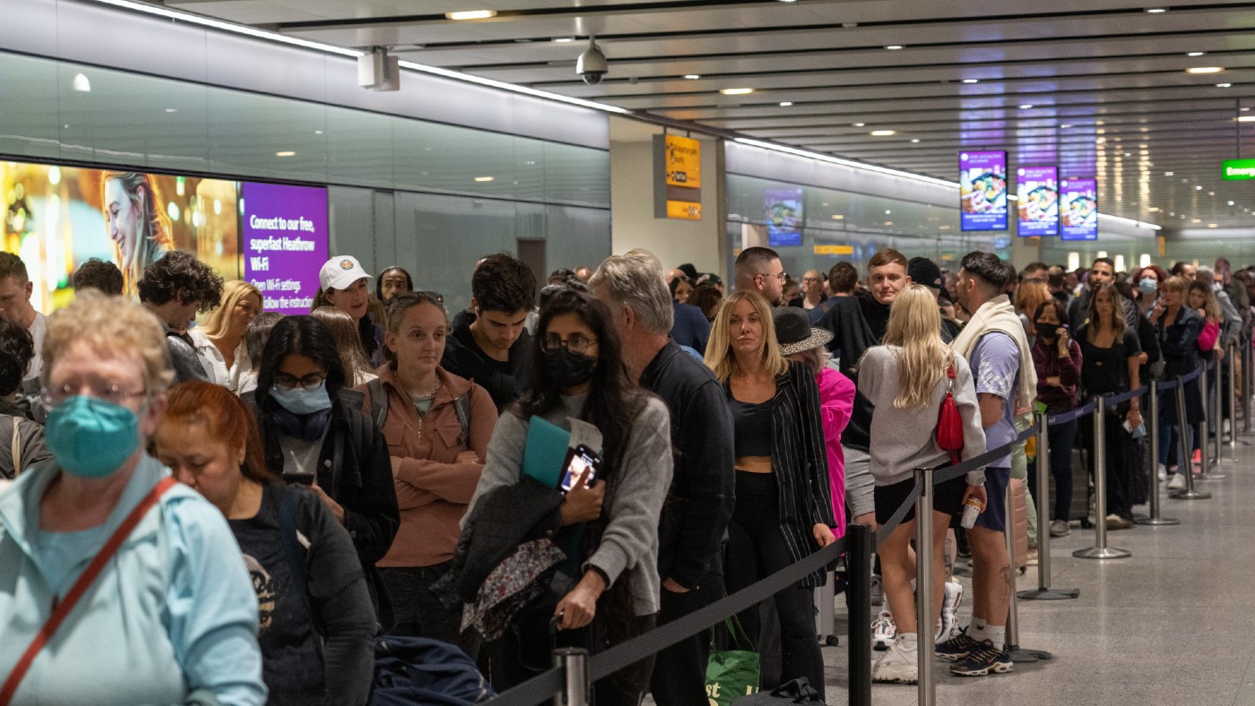 Travellers wait in a long queue 