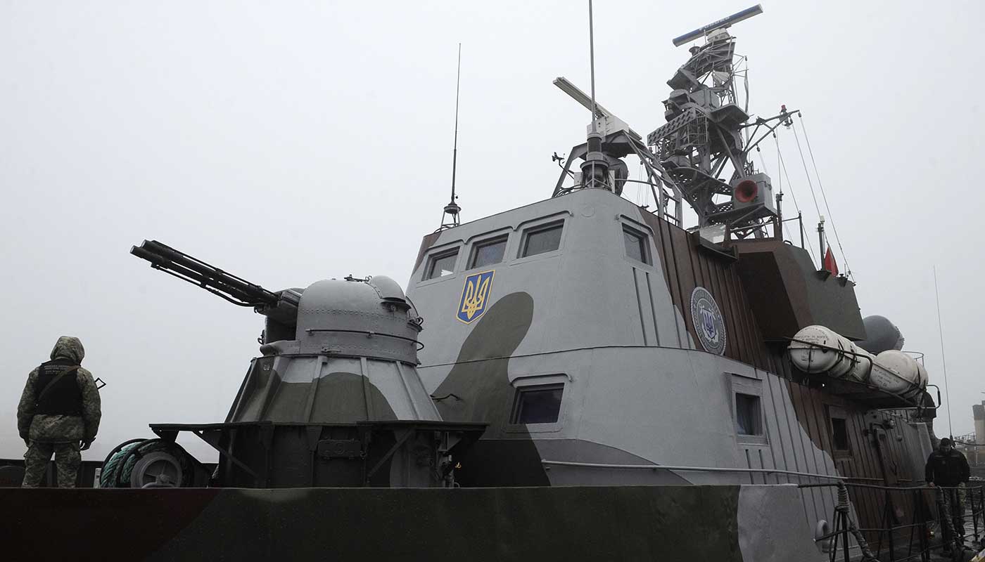 A Ukrainian sailor patrols a gunboat on the Sea of Azov