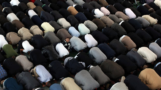 LONDON, ENGLAND - SEPTEMBER 21:Muslim men pray after a speach by the Islamic Khalifa of the Ahmadiyya Muslim community Mirza Masroor Ahmad at Baitul Futuh Mosque in Morden on September 21, 20
