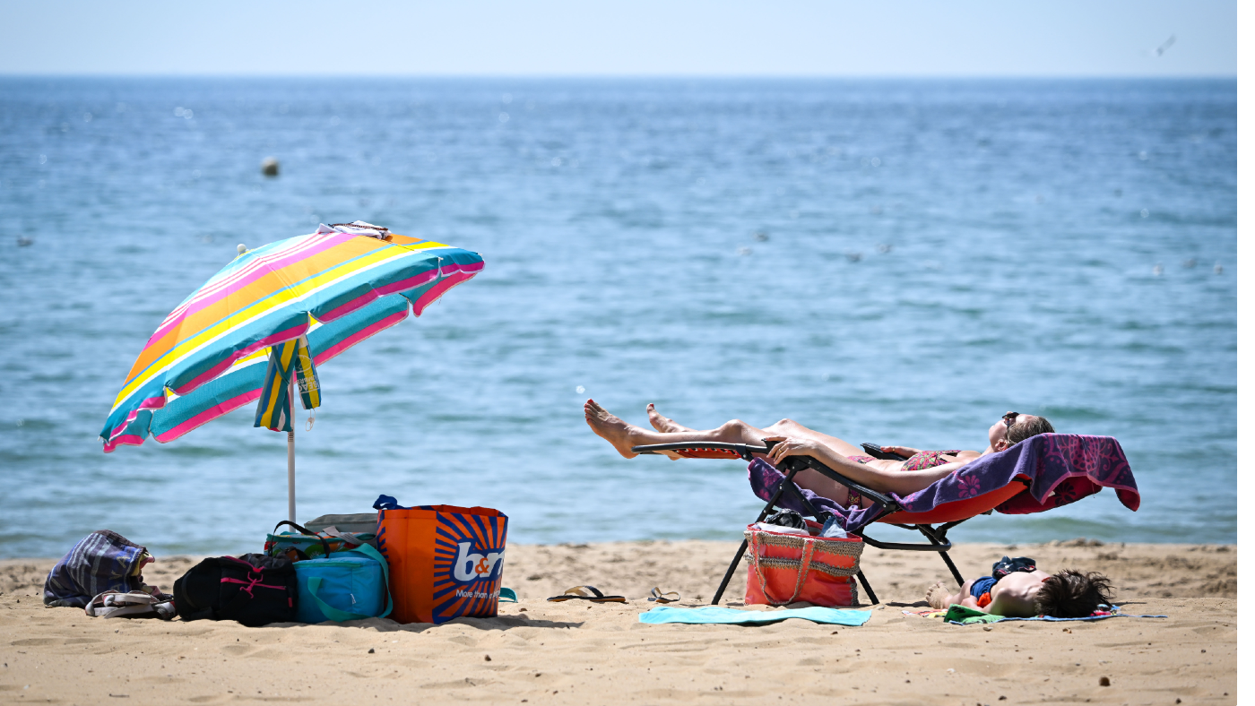 A woman sunbathes on the beach