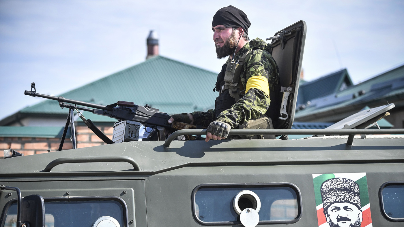 A Chechen special force trooper sits atop an APC decorated with a portrait of former Chechen president Akhmad Kadyrov, the father of the current Chechen leader Ramzan Kadyrov, during a traini