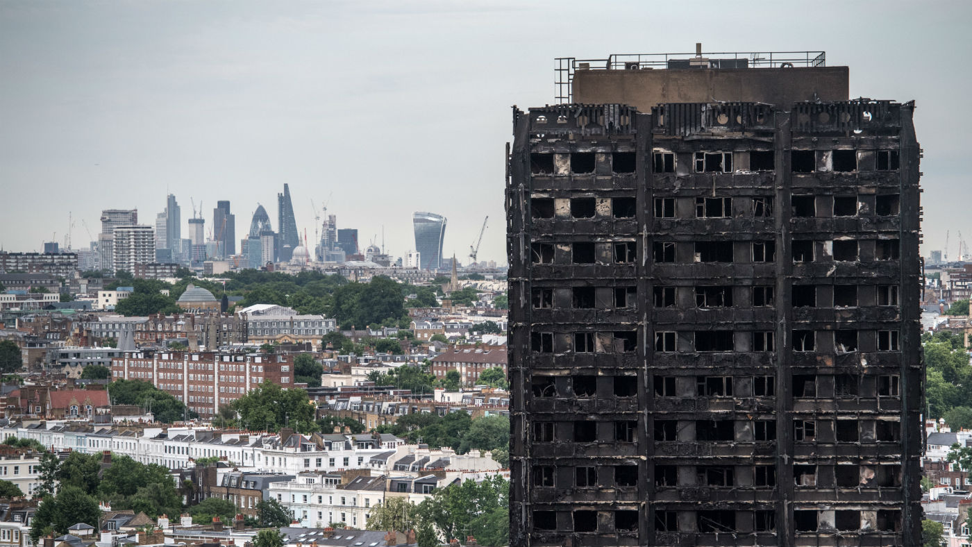 The City of London skyline seen behind the remains of Grenfell Tower