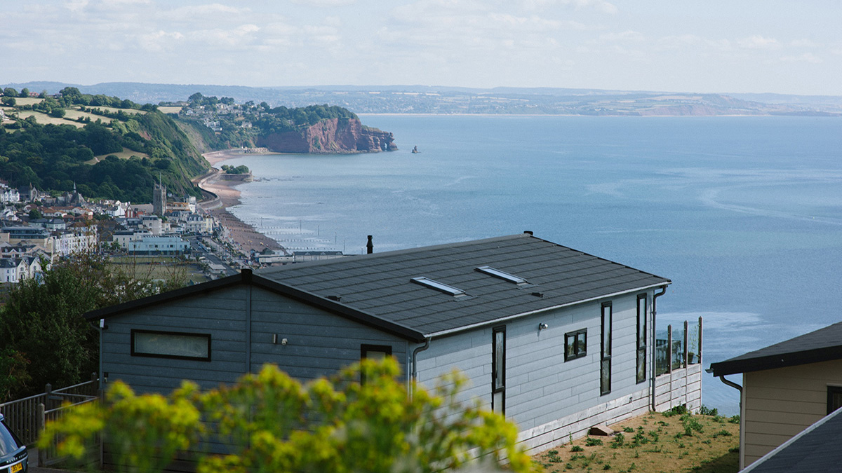 A view over the back of a house of a town and coastal bay