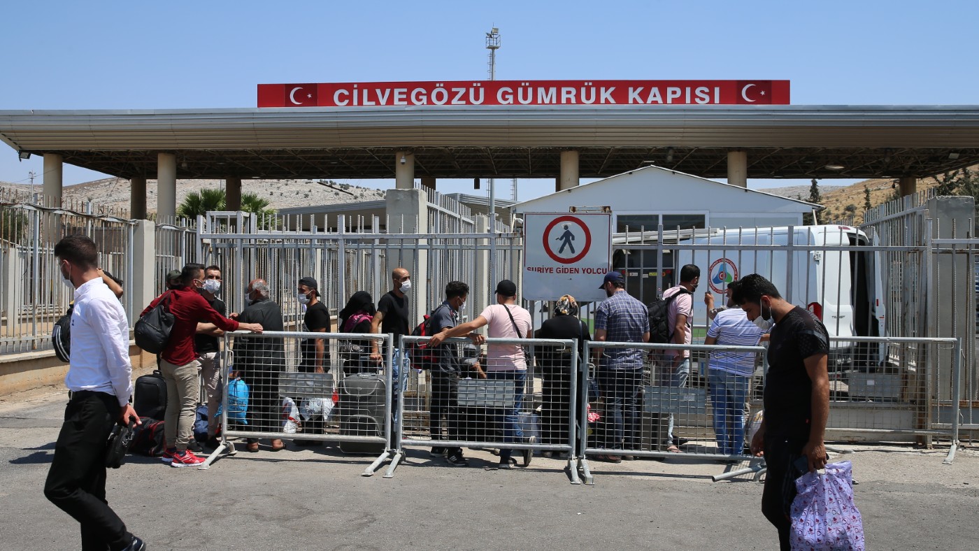 People queuing at a border gate in Turkey