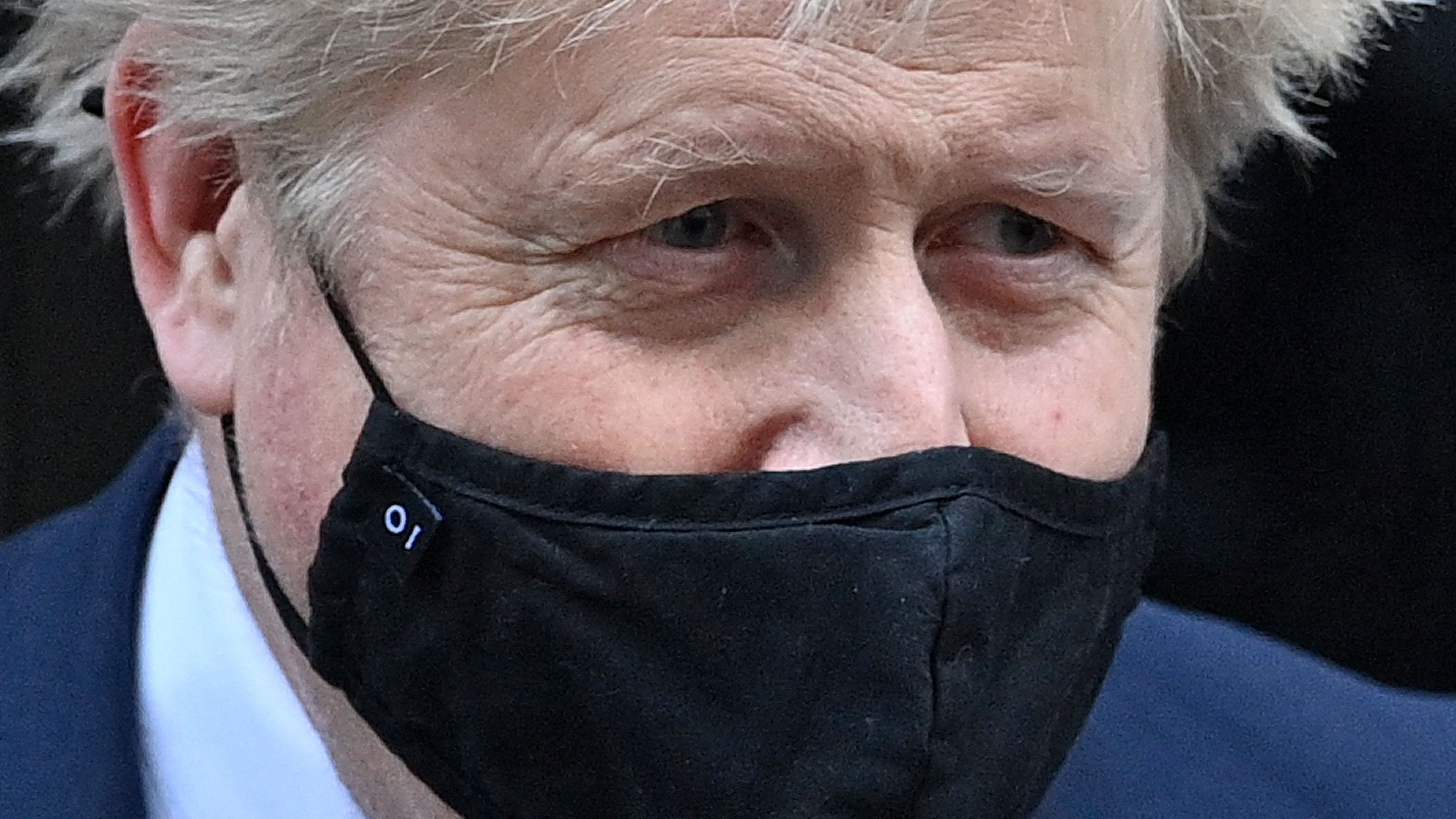 Boris Johnson leaves No. 10 Downing Street wearing a face mask