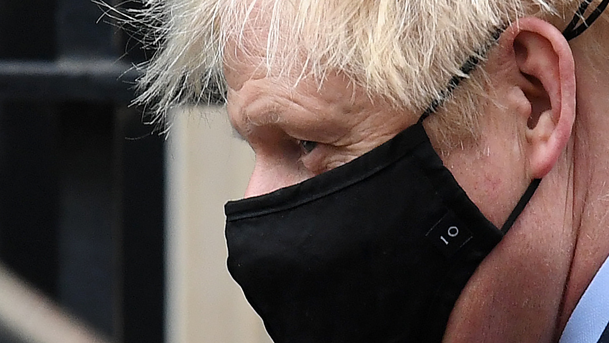 Boris Johnson leaves Downing Street wearing a No 10 embroidered face mask.