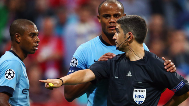 Fernandinho and Vincent Company of Manchester discuss with referee Alberto Undiano Mallenco during the UEFA Champions League 