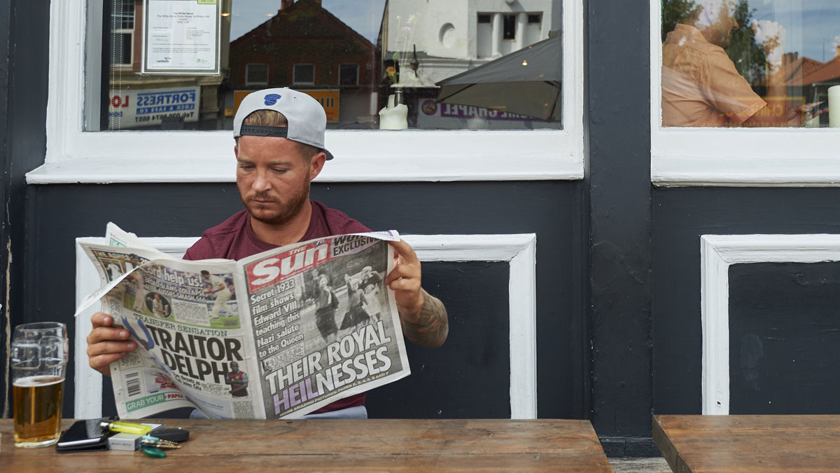 Man reads The Sun newspaper