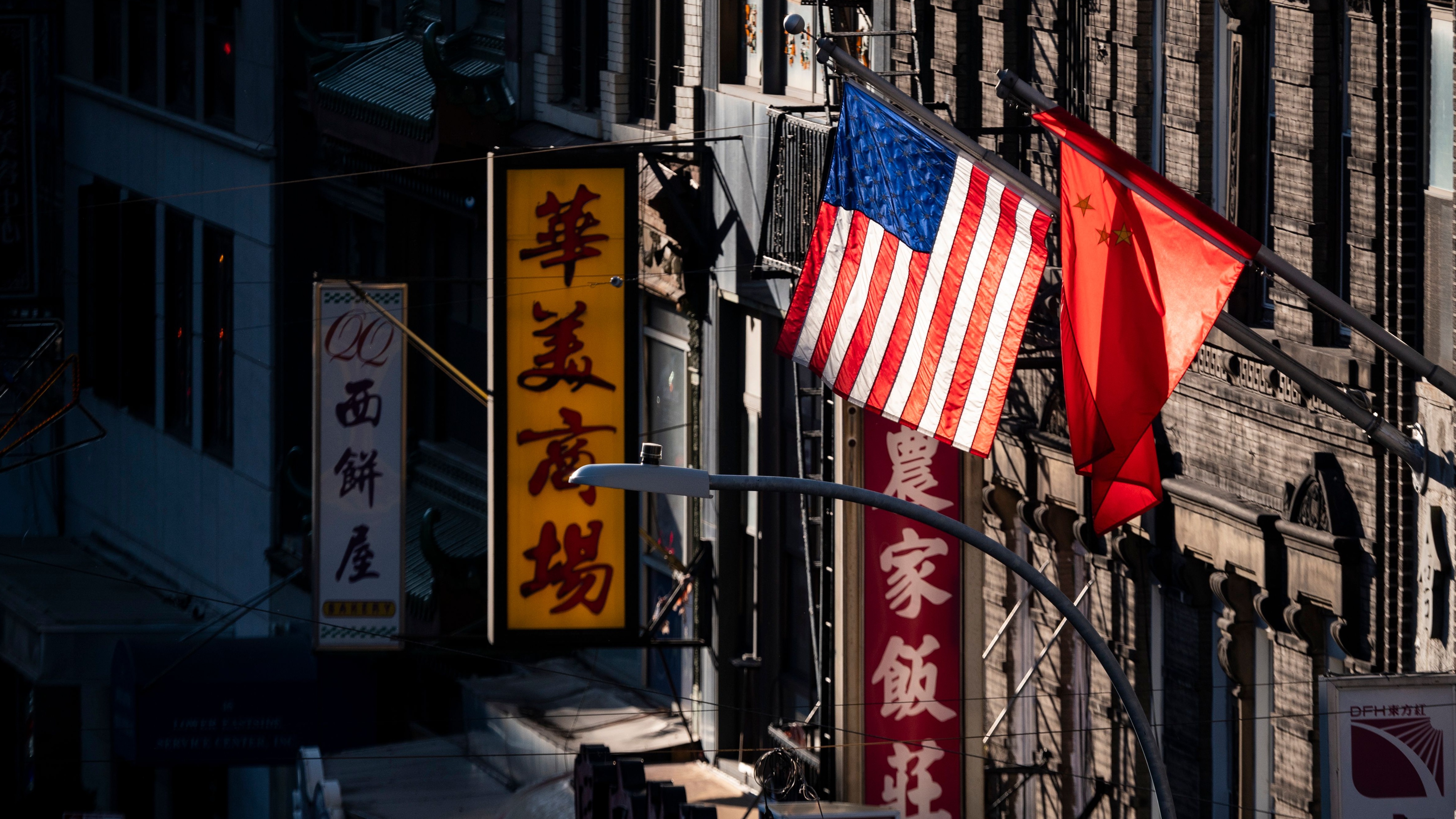 The US and Chinese flags flying over Chinatown in New York City