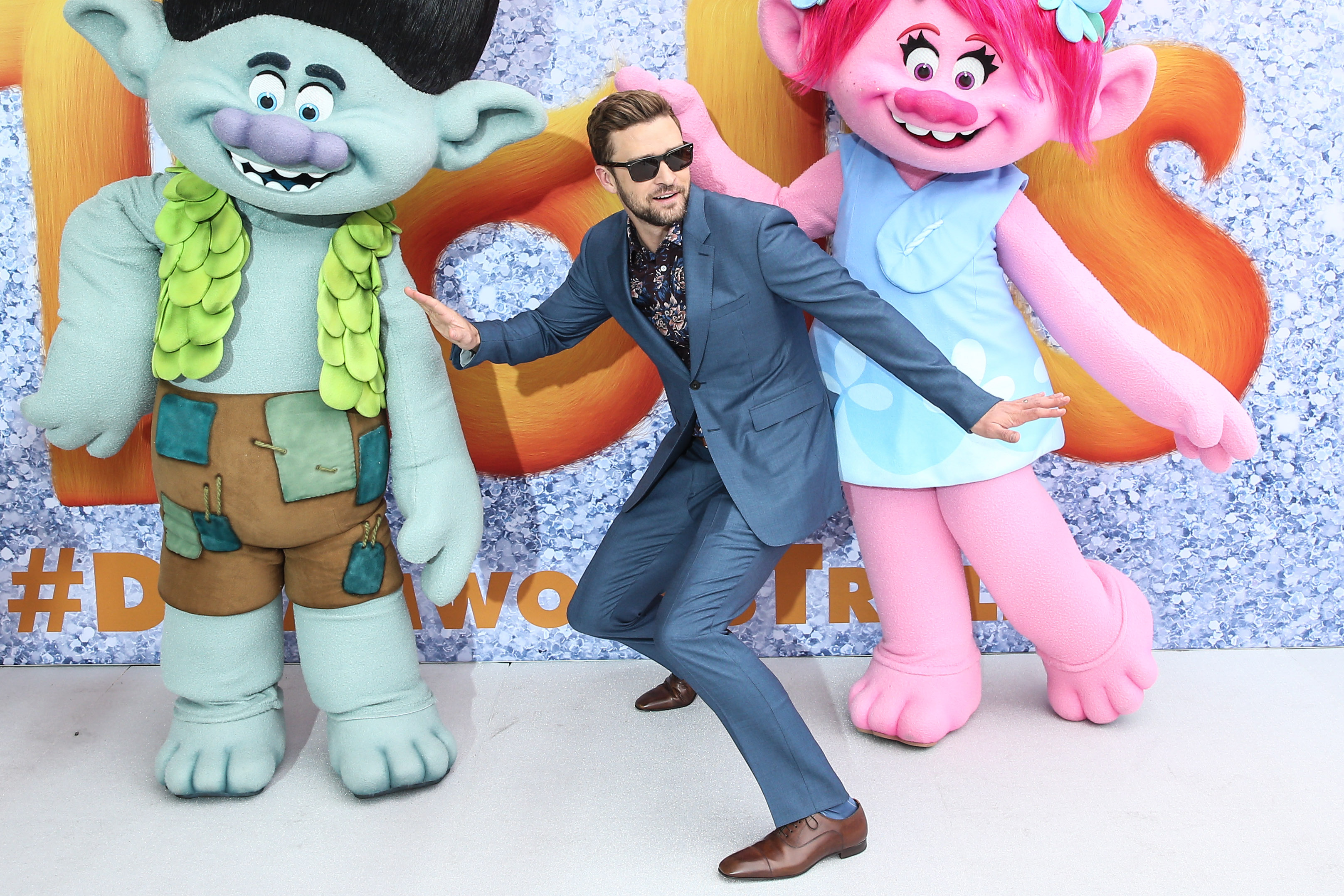 Justin Timberlake posing on the red carpet at Trolls Movie Premiere Sydney with characters Branch and Poppy.