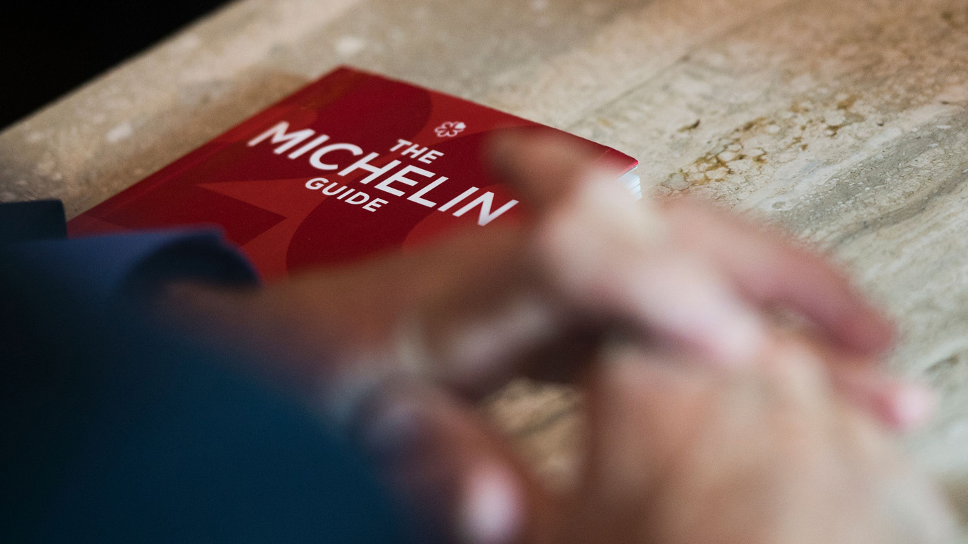 Michael Ellis from Michelin poses with the Michelin guide book at a restaurant in Washington, DC on October 12, 2016. The Michelin Guide unveiled its first edition for the US capital Washingt