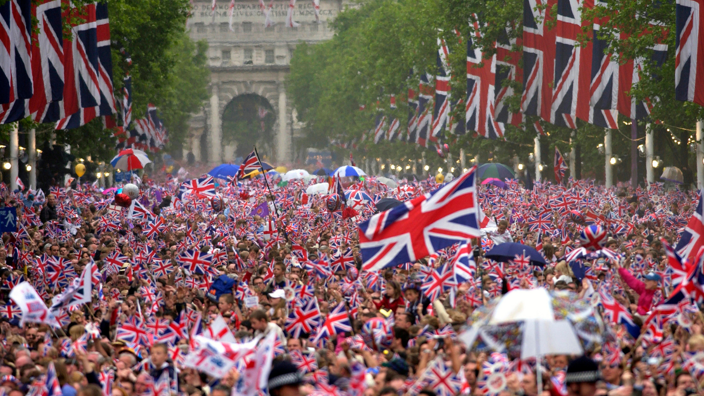 Crowds fill the mall waving Union Jack flags