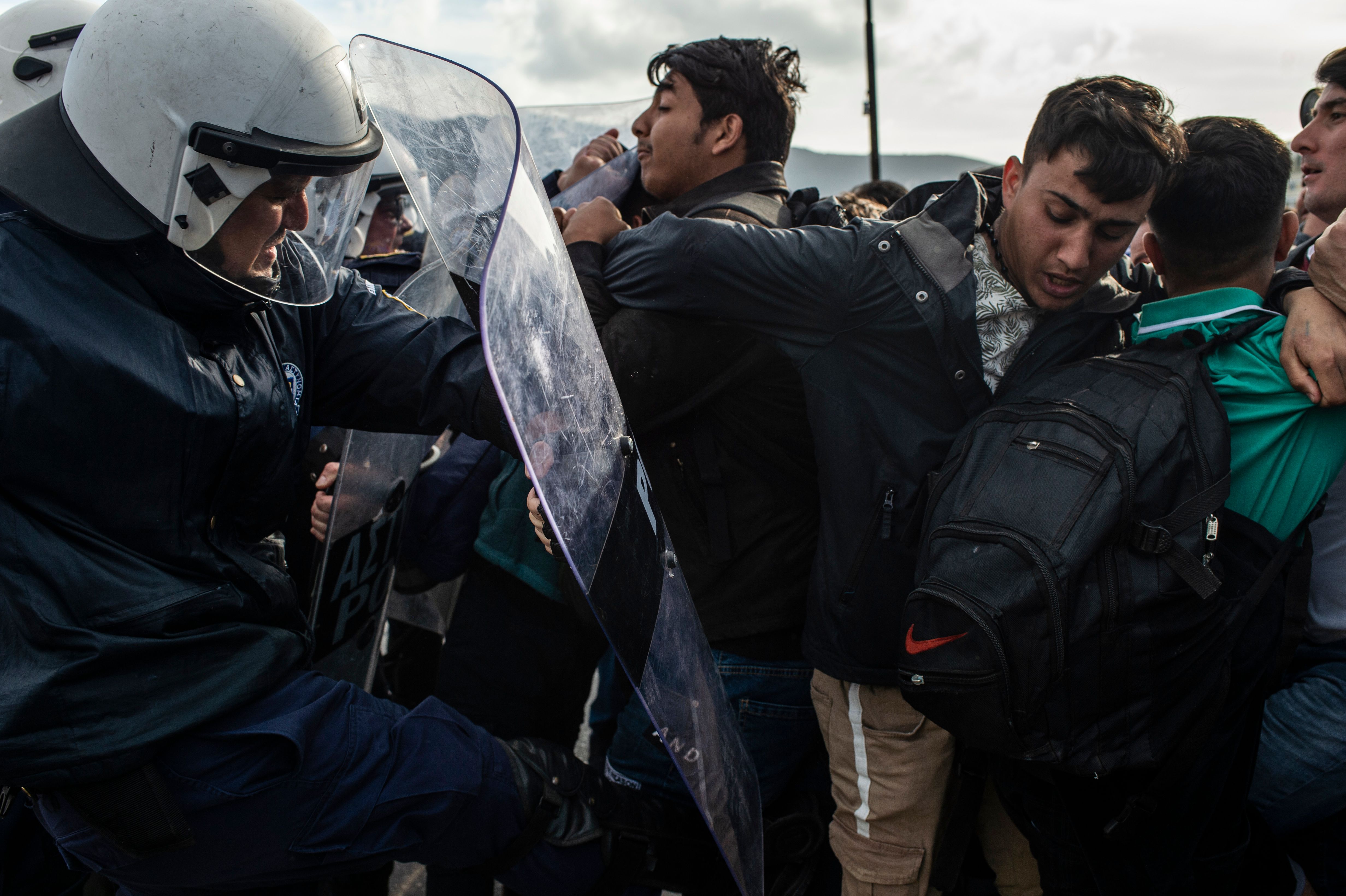 Refugees scuffle with riot police on the Greek island of Lesbos