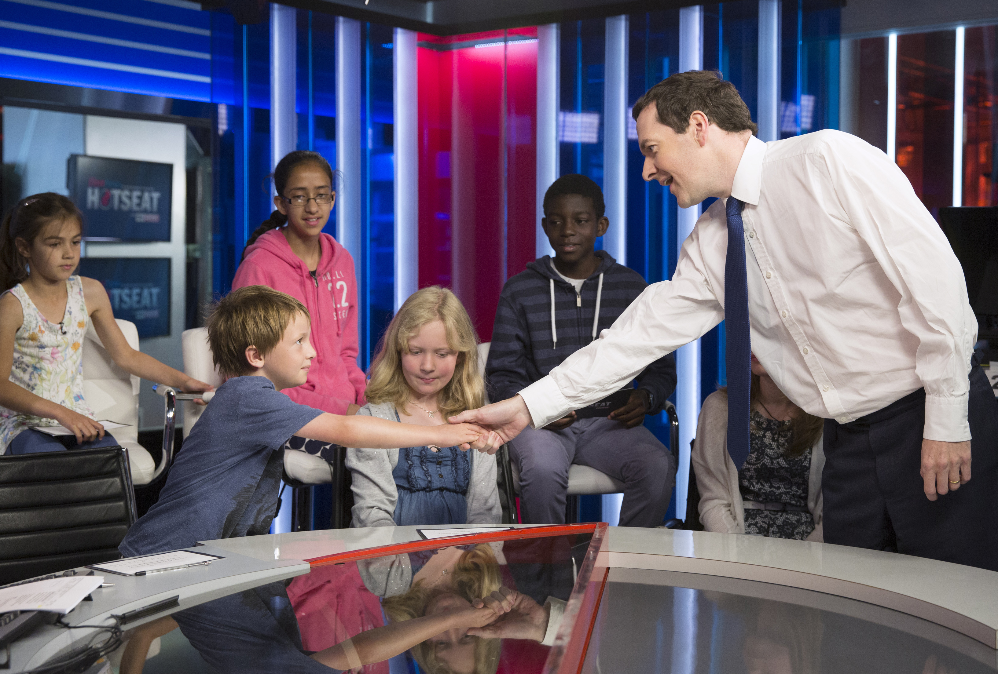 George Osborne shakes hands with seven-year-old Sam Raddings
