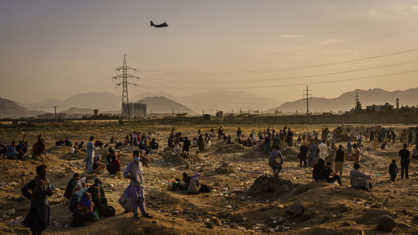 Civilians watch as plans fly out of Kabul