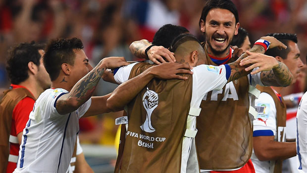 Arturo Vidal of Chile celebrates victory over Spain with his teammates