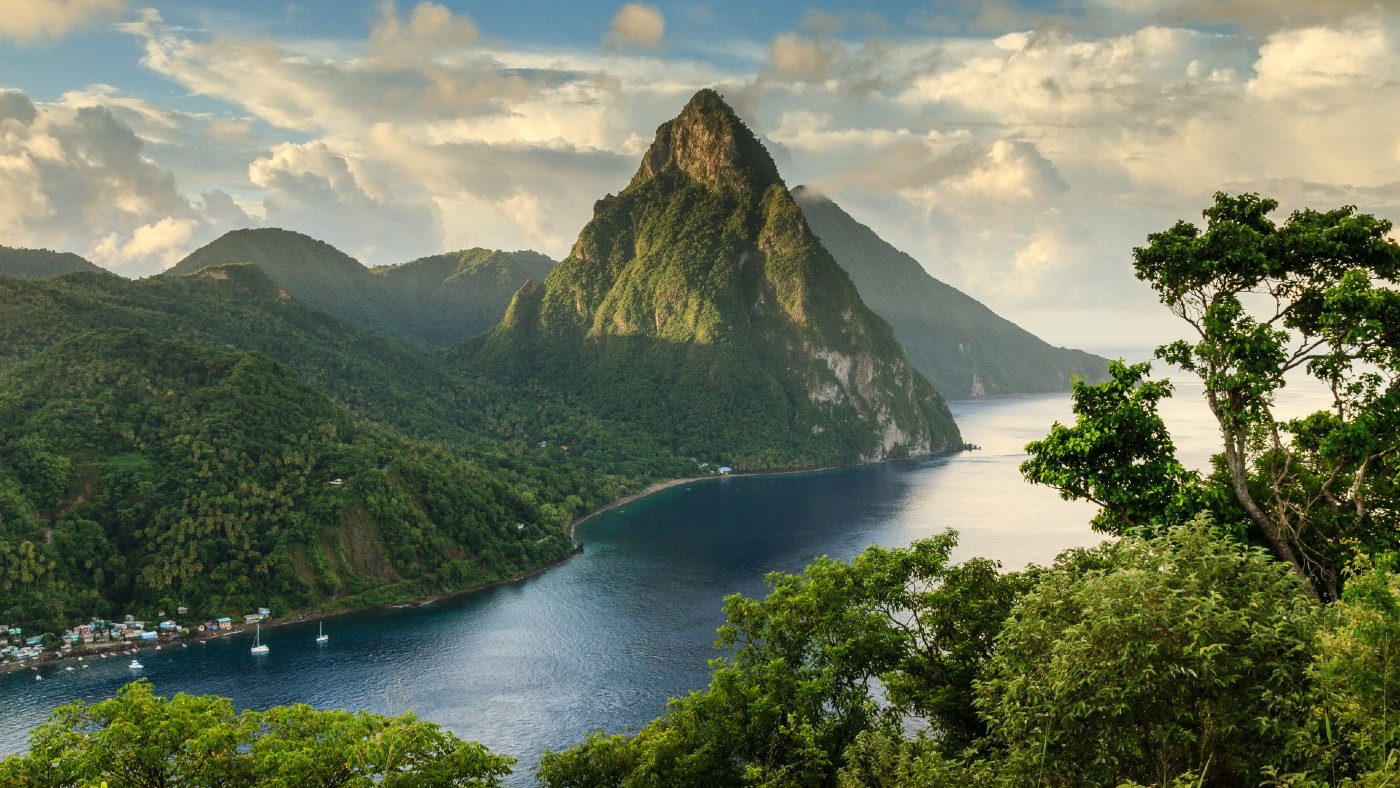 Stunning view of the Pitons (Petit Piton &amp; Gros Piton) from an elevated viewpoint with the rainforest and bay of Soufrière in the foreground