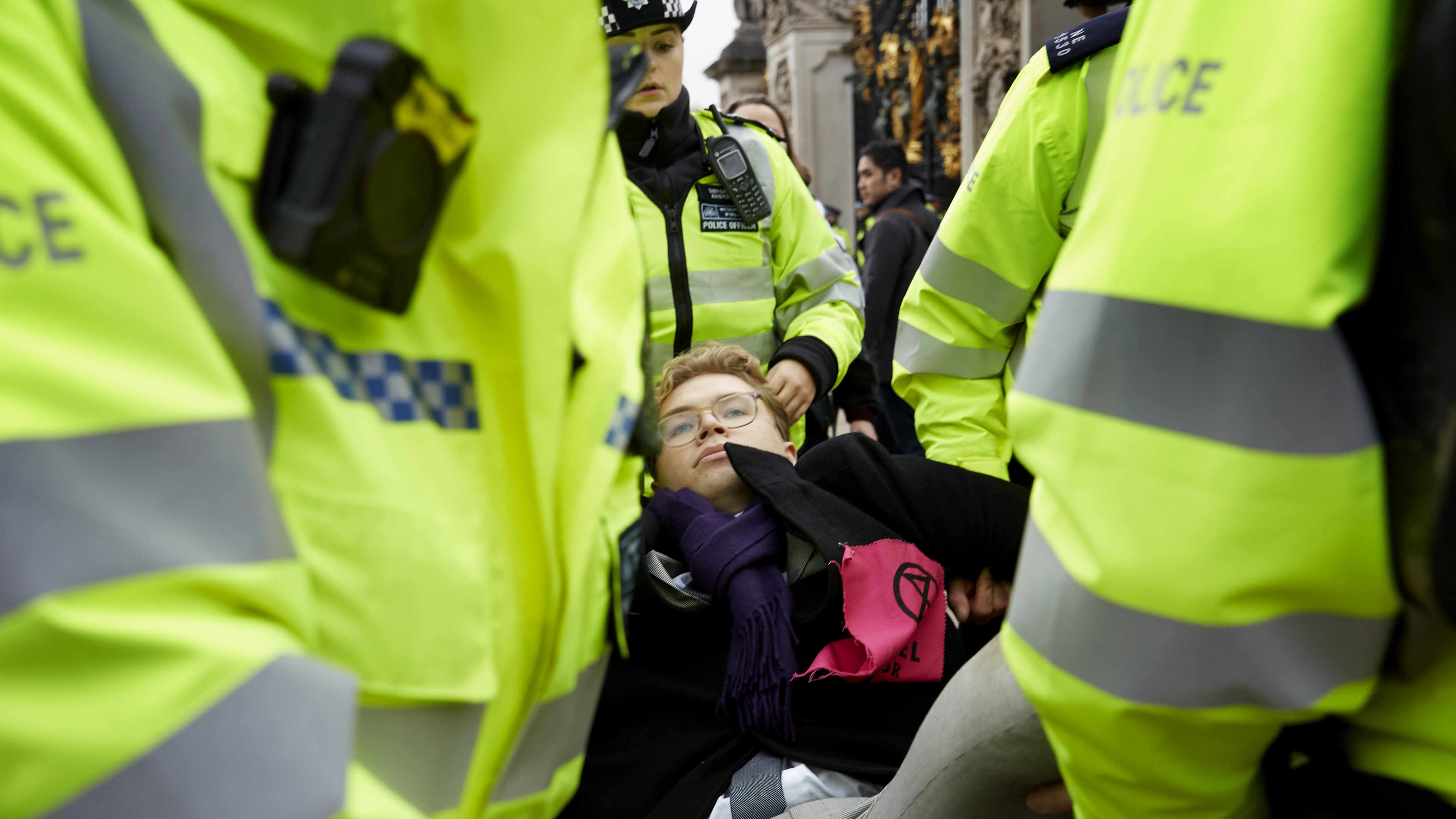 An Extinction Rebellion demonstrator is carried away by a police officers