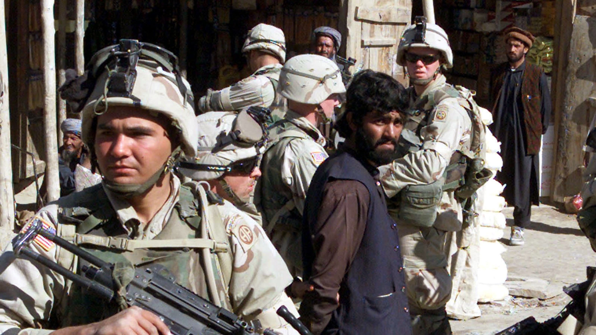 US troops of the 82nd Airborne Division question Afghan men in Kabul, Afghanistan