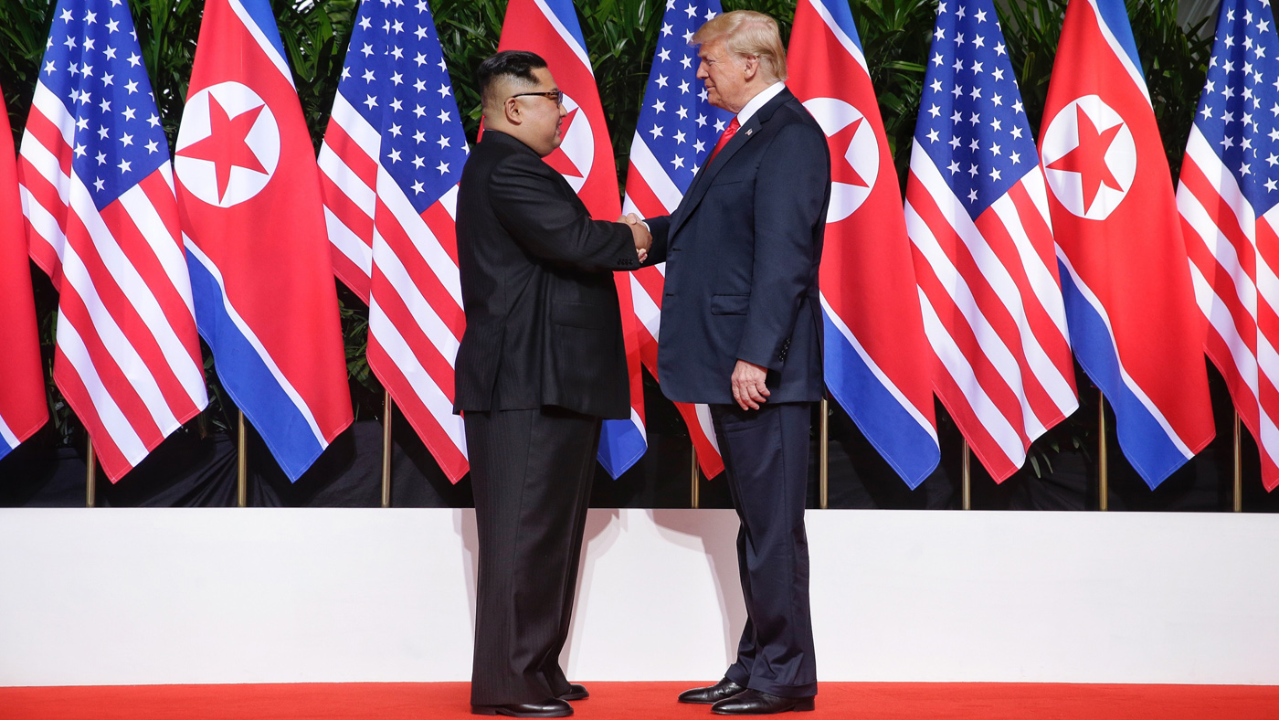SINGAPORE - JUNE 12: In this handout photo, North Korean leader Kim Jong-un (L) shakes hands with U.S. President Donald Trump (R) during their historic U.S.-DPRK summit at the Capella Hotel o